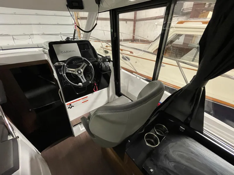 Slide: The Image of Interior of 2022 Beneteau Antares 9 boat with steering wheel and Garmin navigation system. - 24