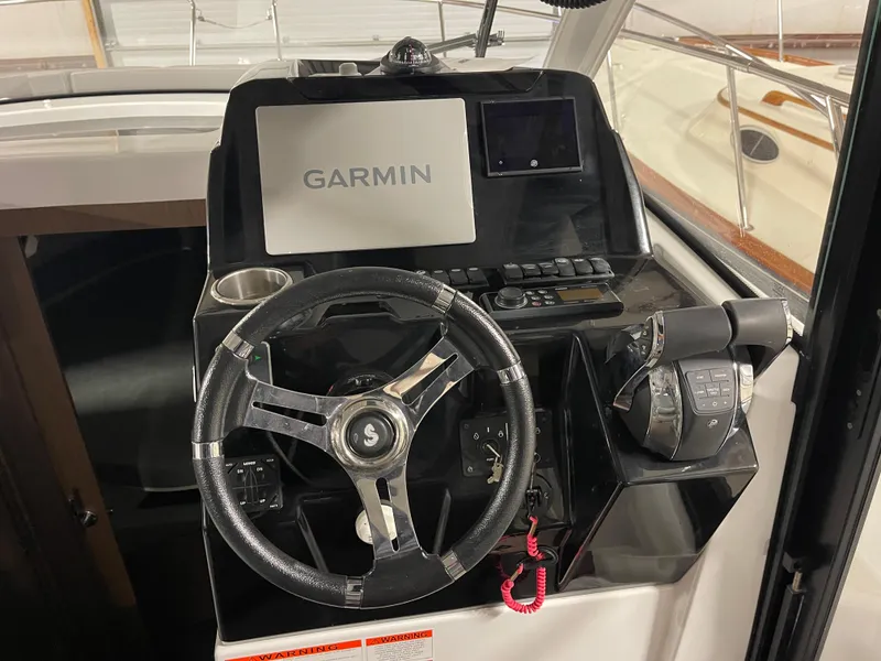 Slide: The Image of 2022 Beneteau Antares 9 helm with Garmin navigation system and steering wheel. - 25