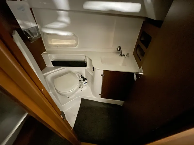 Slide: The Image of 2022 Beneteau Antares 9 bathroom interior with compact toilet and sink. - 26