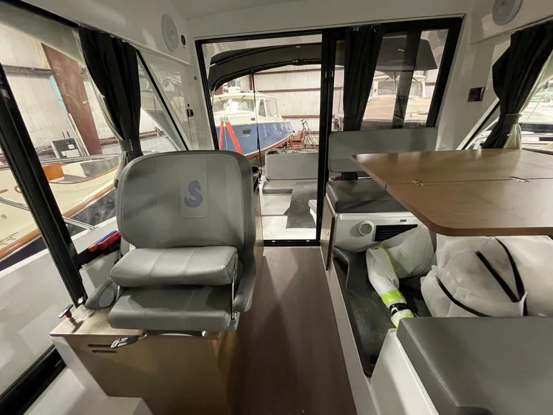 Slide: The Image of Interior of 2022 Beneteau Antares 9 boat, featuring seating and dining area. - 29