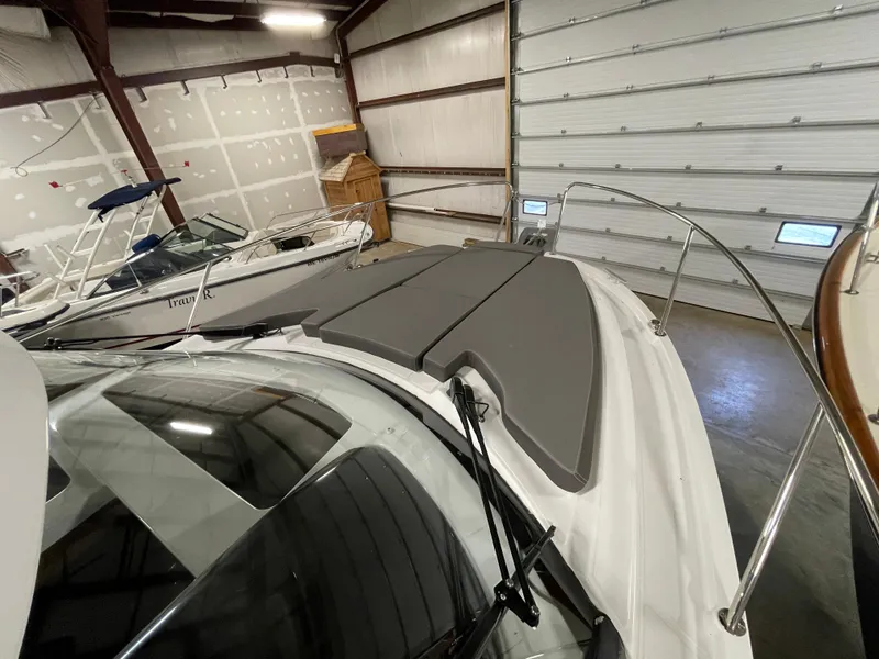 Slide: The Image of 2022 Beneteau Antares 9 boat in indoor storage, featuring sleek design and modern amenities. - 33