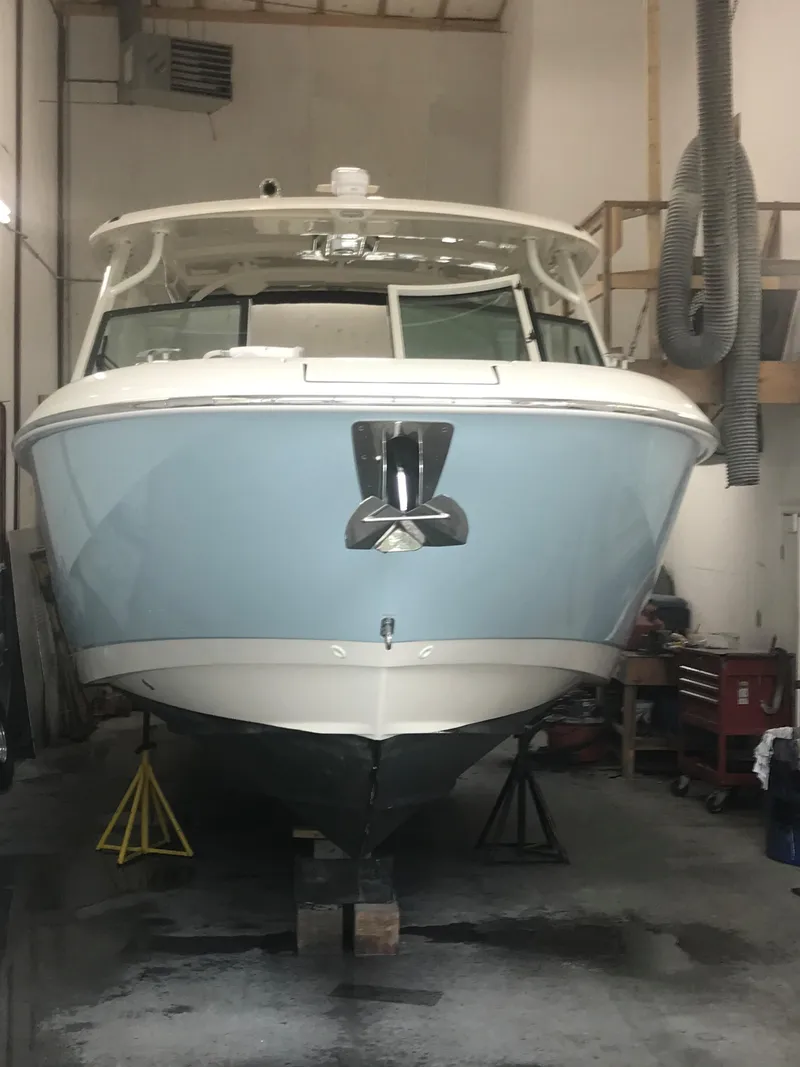 Slide: The Image of 2021 Boston Whaler 320 Vantage boat in a workshop setting. - 18