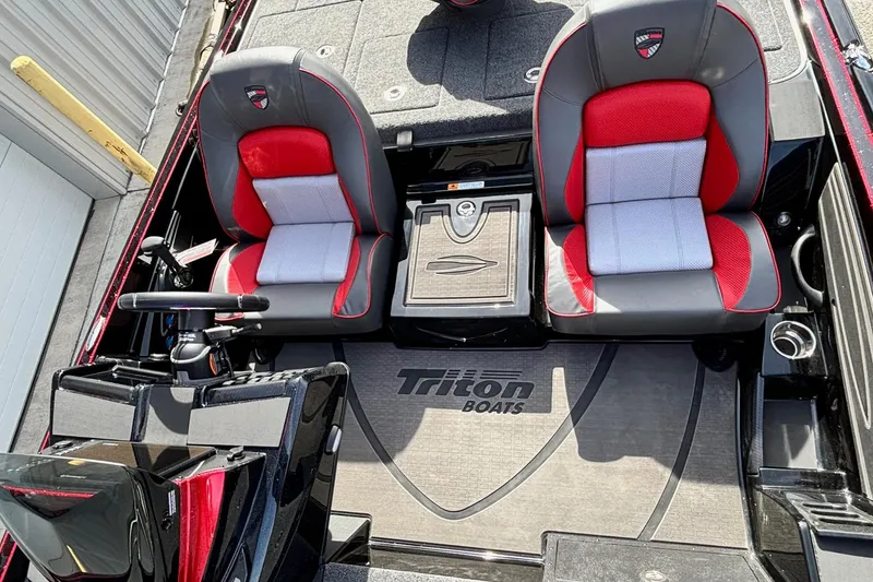 Slide: The Image of 2025 Triton 20XP Patriot boat interior with red and gray seats, steering console, and branded flooring. - 12