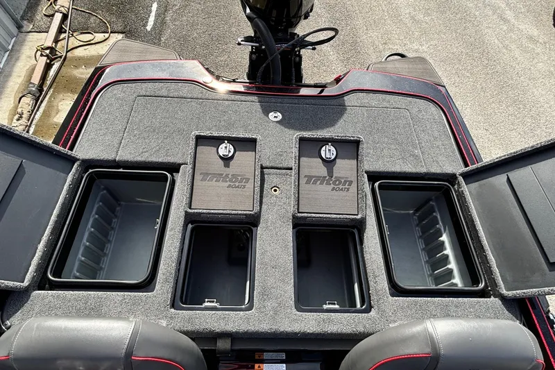 Slide: The Image of 2025 Triton 20XP Patriot boat storage compartments with open lids, showcasing interior space. - 13