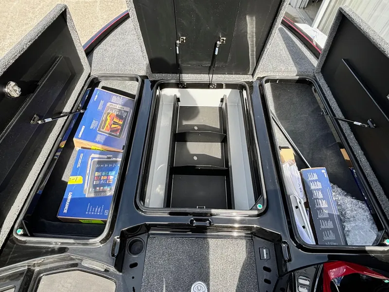 Slide: The Image of 2025 Triton 20XP Patriot boat storage compartments with electronics and accessories. - 5