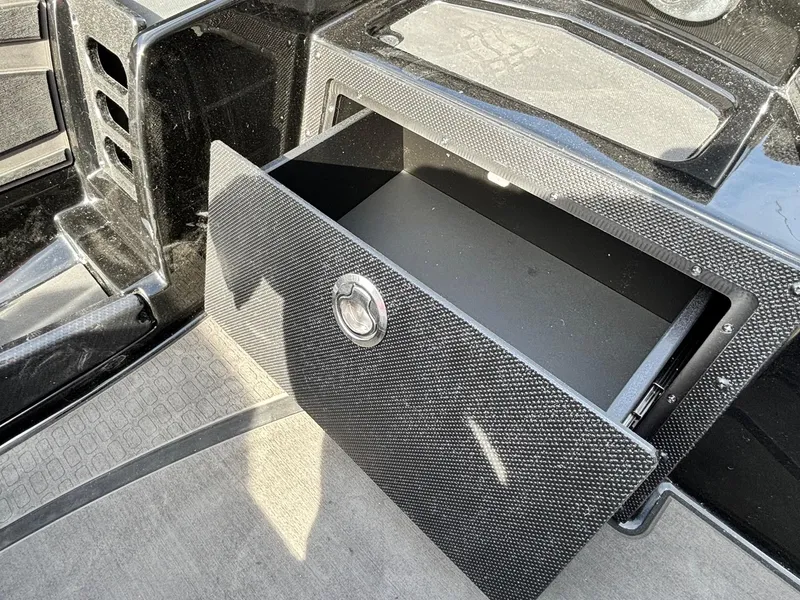 Slide: The Image of Open storage compartment in 2025 Triton 20XP Patriot boat. - 6