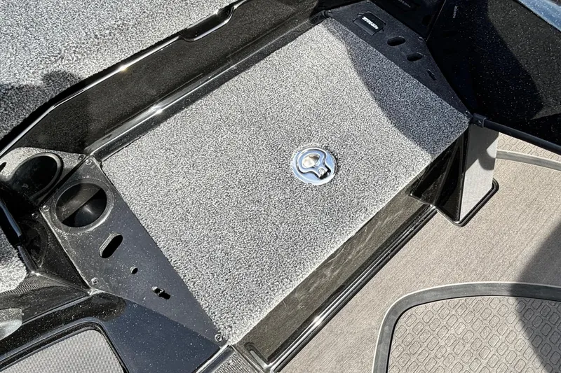 Slide: The Image of 2025 Triton 20XP Patriot boat deck with textured surface and storage compartment. - 8