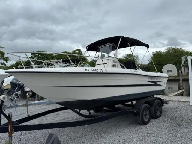 Slide: The Image of 1994 Hydra-Sports 2000 CC boat on trailer, parked outdoors under cloudy sky. - 0