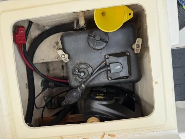 Slide: The Image of 1994 Hydra-Sports 2000 CC boat compartment with fuel tank and yellow funnel. - 12