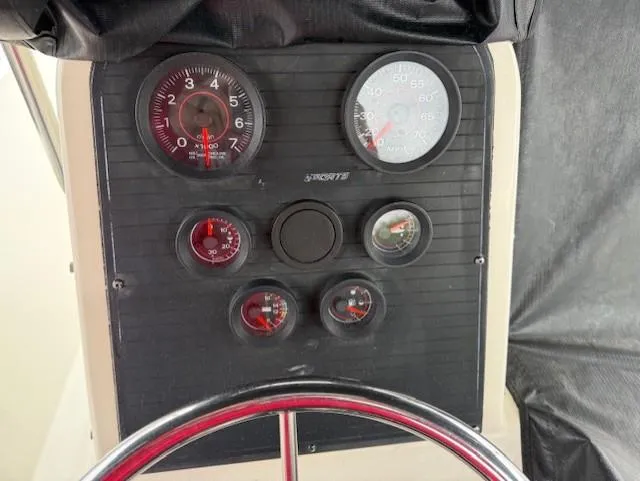 Slide: The Image of Dashboard of a 1994 Hydra-Sports 2000 CC boat with gauges and steering wheel. - 6