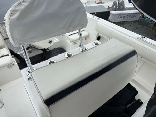 Slide: The Image of 1994 Hydra-Sports 2000 CC boat interior with white seating and rod holders. - 8