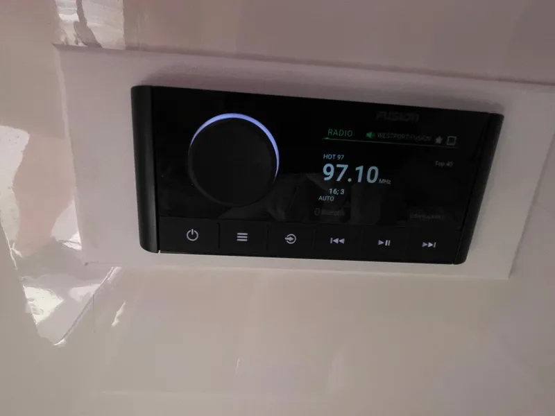 Slide: The Image of Boat stereo system displaying radio station 97.10 FM on a 2014 Southport 27 Center Console. - 12