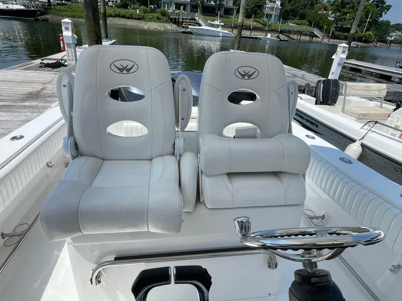 Slide: The Image of 2014 Southport 27 Center Console boat with dual white captain's chairs at the helm. - 13