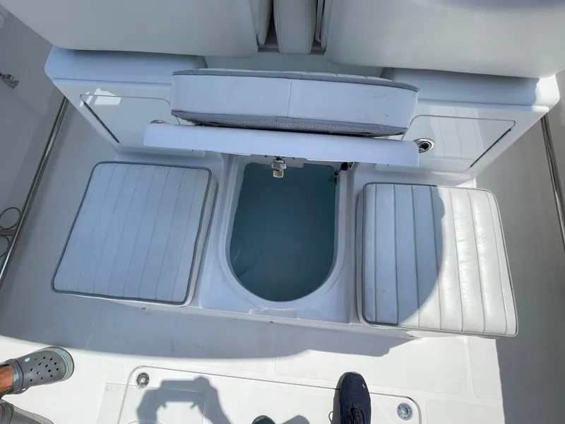 Slide: The Image of 2014 Southport 27 Center Console boat interior with seating and storage compartments. - 19