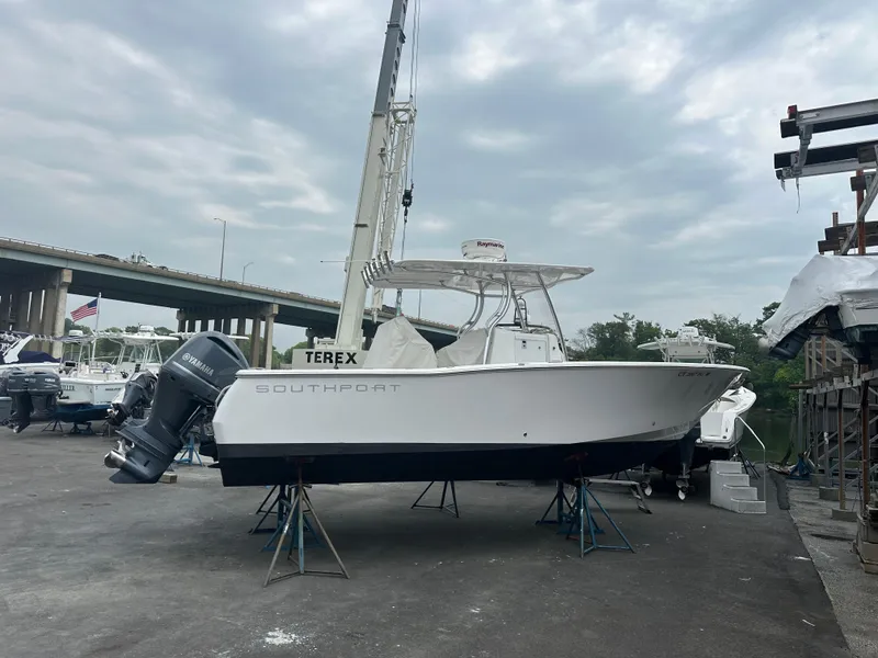 Slide: The Image of 2014 Southport 27 Center Console boat on stands in a marina setting. - 2