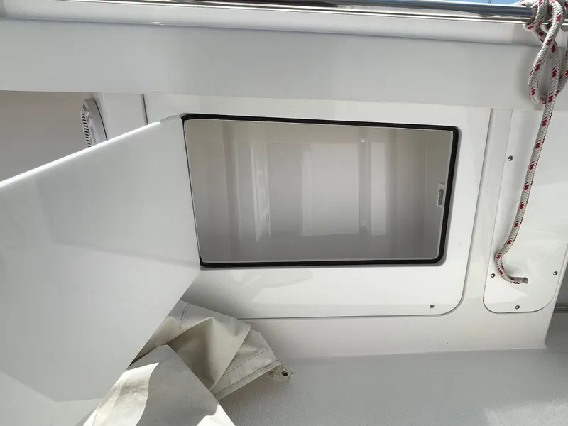 Slide: The Image of Open storage compartment on a 2014 Southport 27 Center Console boat. - 22