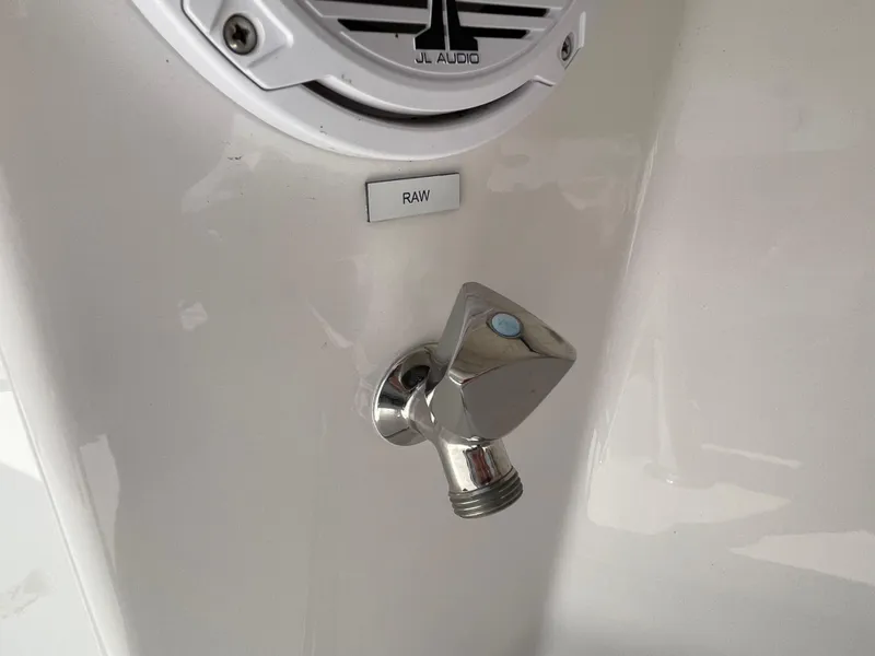 Slide: The Image of Chrome faucet on 2014 Southport 27 Center Console boat, near JL Audio speaker. - 23