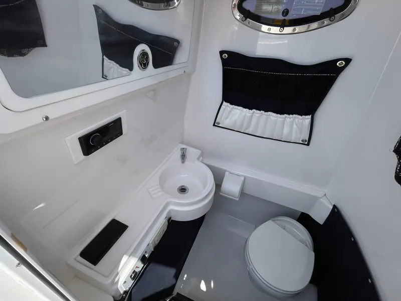 Slide: The Image of 2014 Southport 27 Center Console boat interior with sink and toilet. - 28