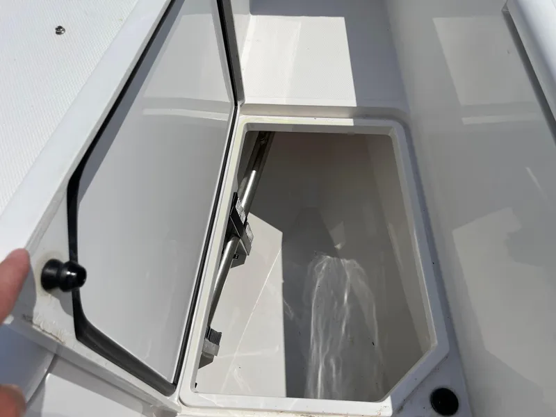 Slide: The Image of Open storage compartment on a 2014 Southport 27 Center Console boat. - 29