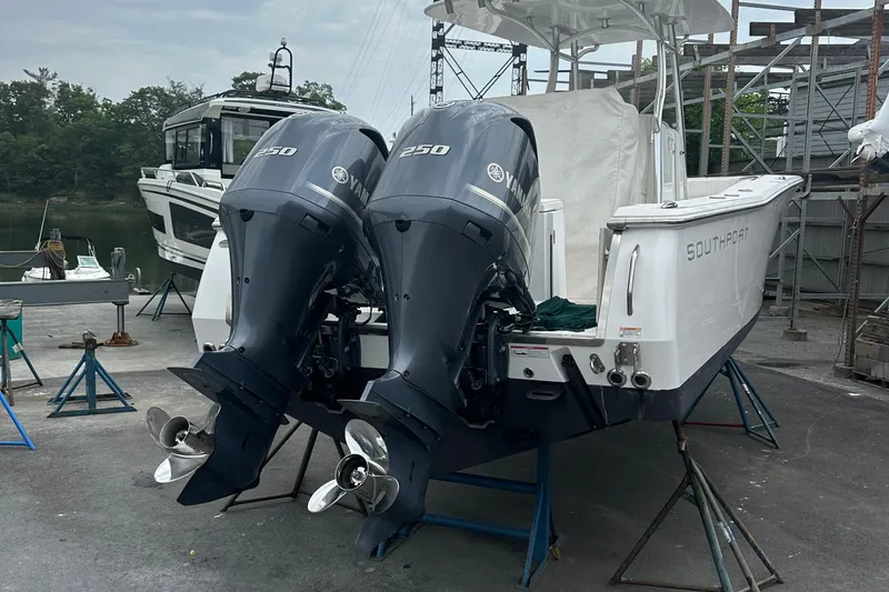 Slide: The Image of 2014 Southport 27 Center Console boat with twin 250 horsepower engines on a dock. - 3