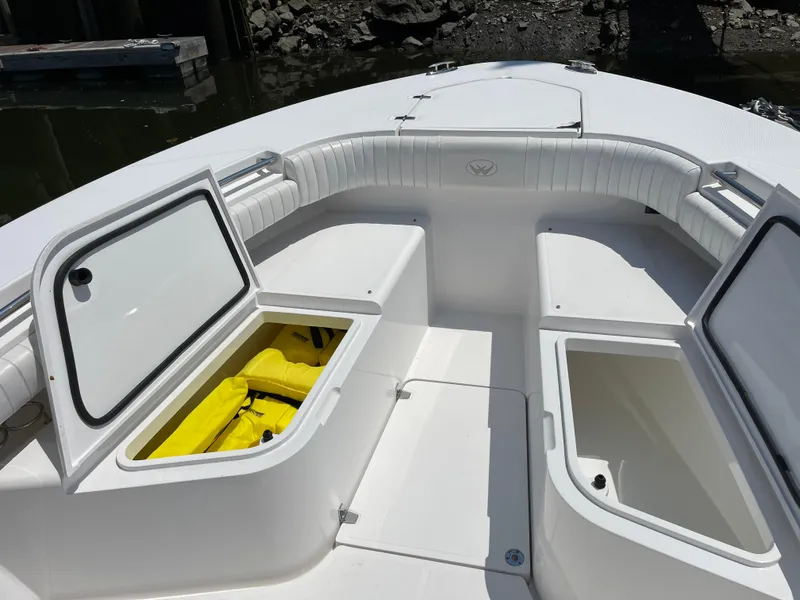 Slide: The Image of 2014 Southport 27 Center Console boat with open storage compartments. - 30