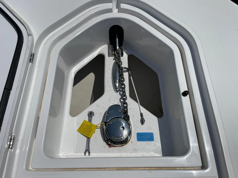 Slide: The Image of Anchor compartment of 2014 Southport 27 Center Console boat with chain and winch. - 32