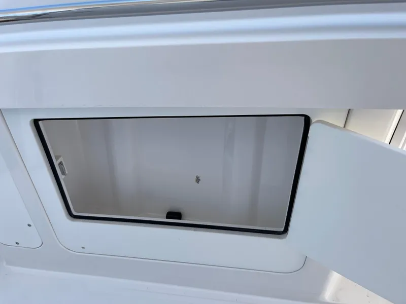 Slide: The Image of Open storage compartment on a 2014 Southport 27 Center Console boat. - 33