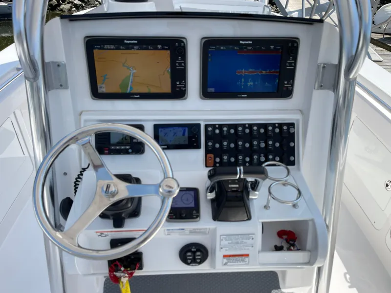Slide: The Image of 2014 Southport 27 Center Console boat dashboard with navigation screens and controls. - 6