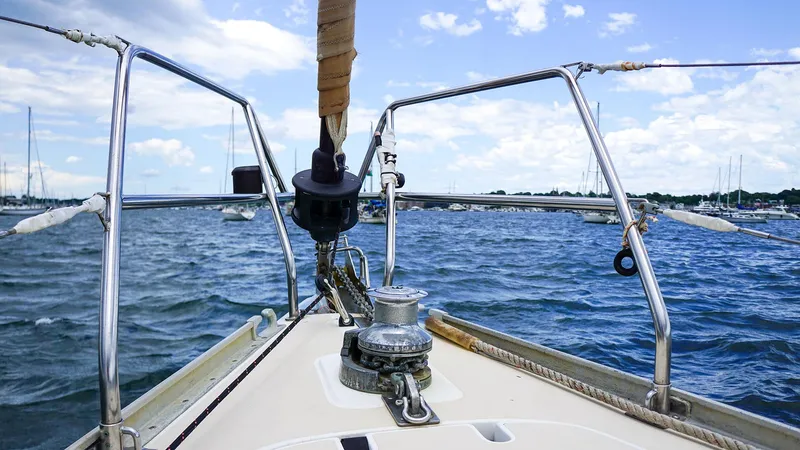 Slide: The Image of 2001 J Boats J/42 sailboat deck view on open water, clear sky, and distant shoreline. - 11