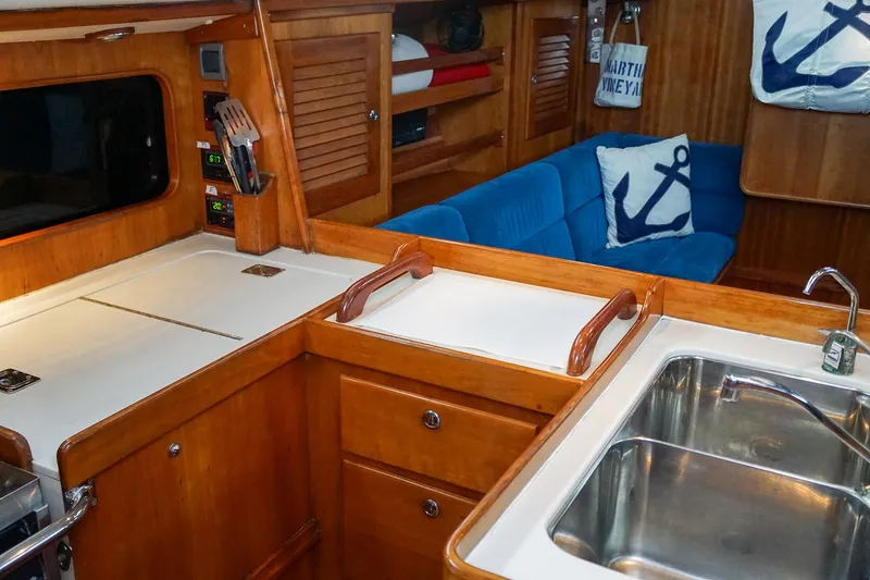 Slide: The Image of Interior of 2001 J Boats J/42 yacht with wooden cabinetry and blue seating. - 19