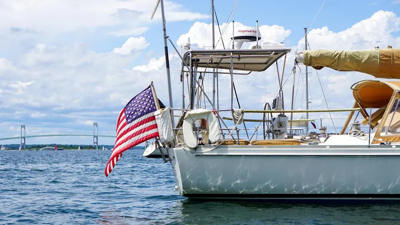 Slide: The Image of Sailboat on water with American flag, J Boats J/42 model, 2001. - 2