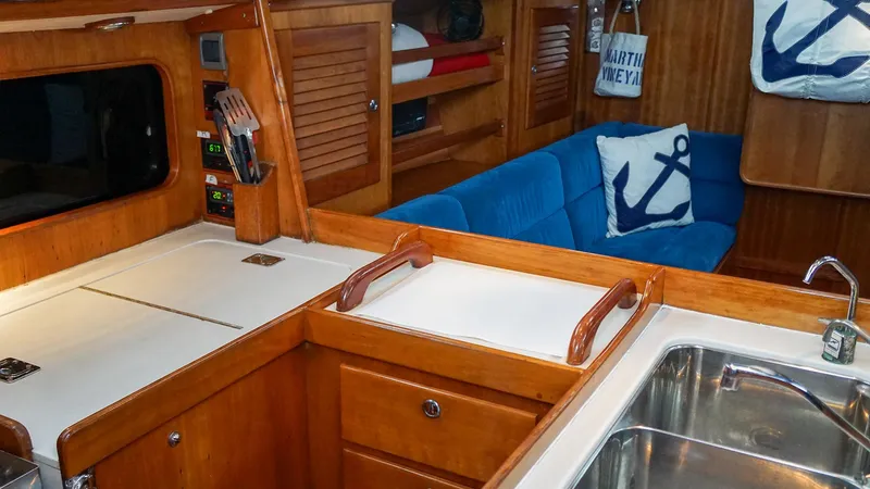 Slide: The Image of Interior of 2001 J Boats J/42 sailboat with wooden cabinetry and blue seating. - 20