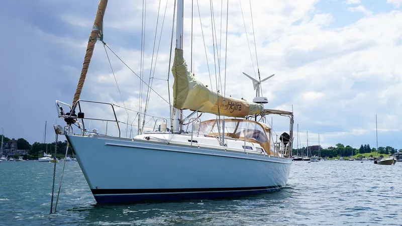 Slide: The Image of 2001 J Boats J/42 sailboat anchored on a calm, scenic waterway. - 3