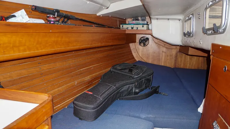 Slide: The Image of 2001 J Boats J/42 cabin interior with wooden paneling and blue cushions. - 34