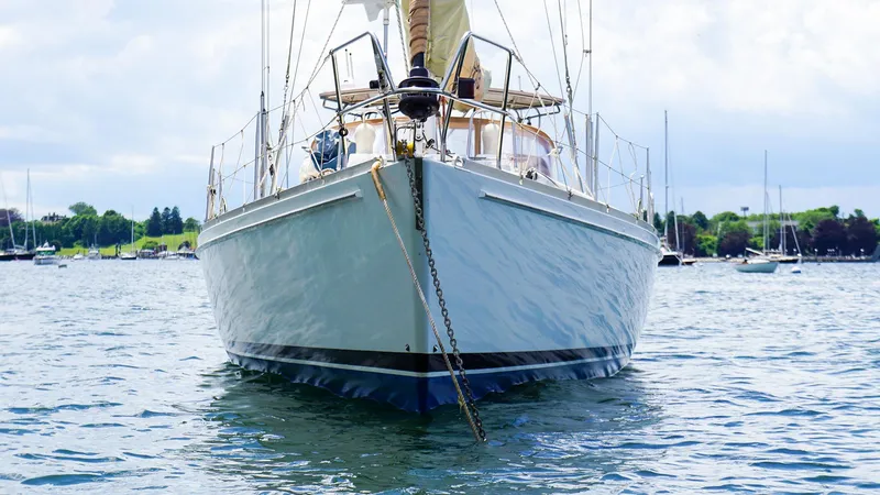 Slide: The Image of 2001 J Boats J/42 sailboat anchored on calm water, front view. - 4