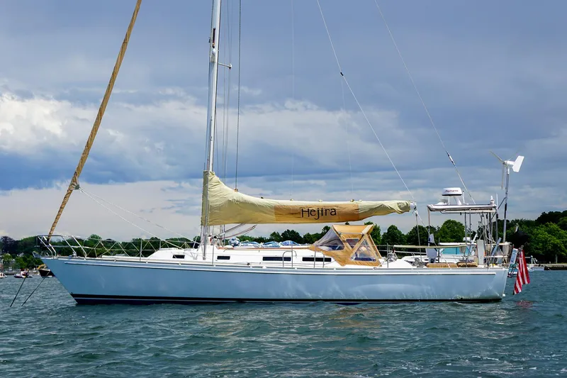 Slide: The Image of 2001 J Boats J/42 sailboat on calm water under a cloudy sky. - 5