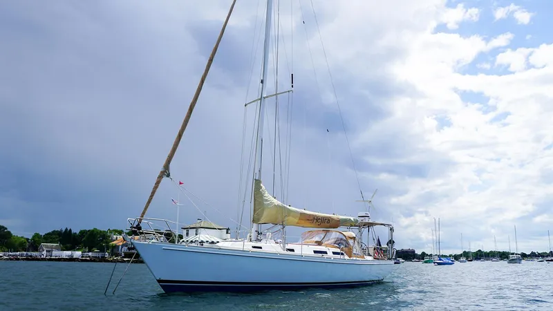 Slide: The Image of 2001 J Boats J/42 sailboat on calm water under cloudy sky. - 7
