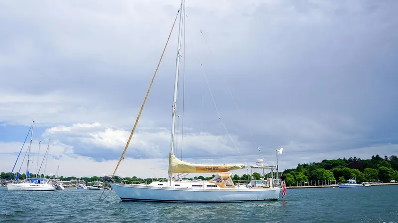 Slide: The Image of 2001 J Boats J/42 sailboat on calm water with cloudy sky background. - 8