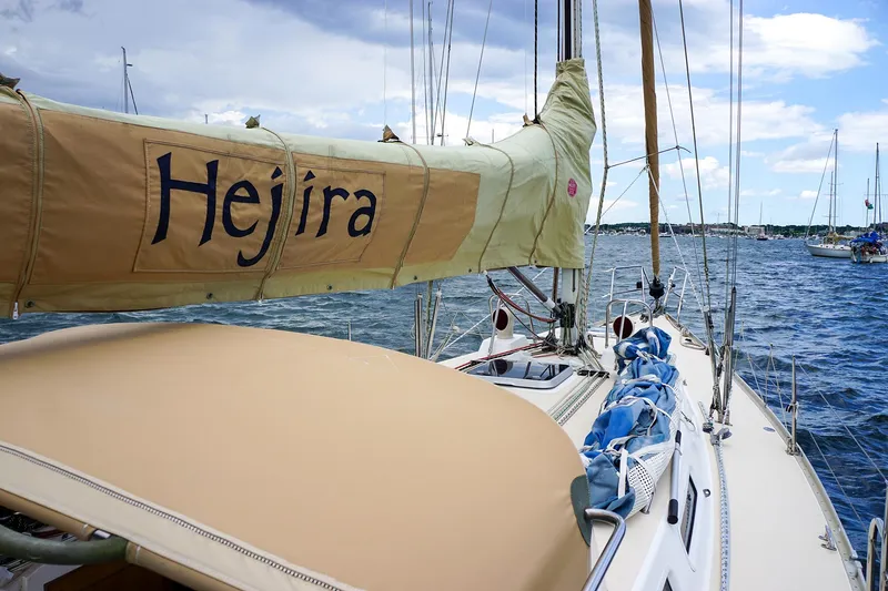 Slide: The Image of 2001 J Boats J/42 sailboat named Hejira on the water, featuring tan sail cover. - 9