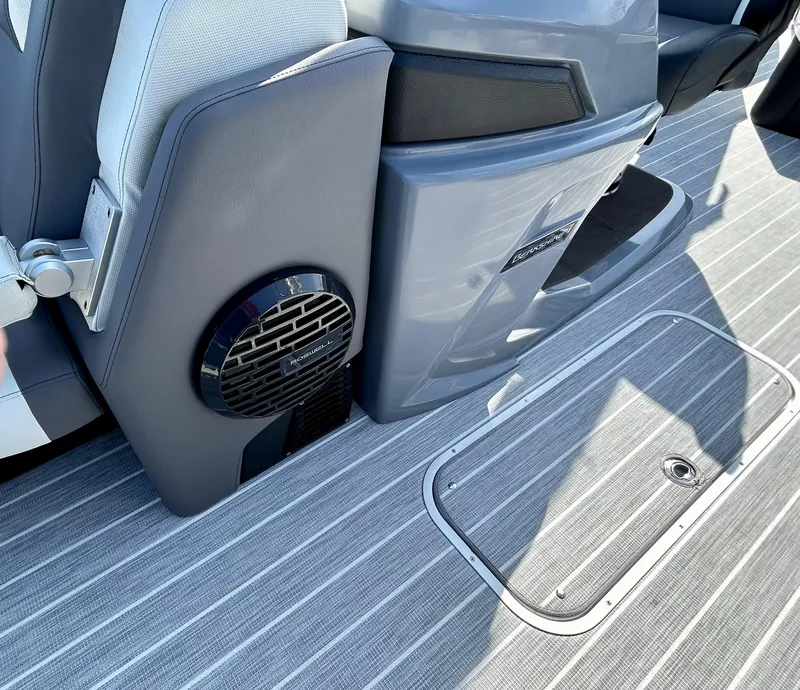Slide: The Image of 2025 Berkshire 23UL STS 3.0 boat interior with speaker and striped flooring. - 10