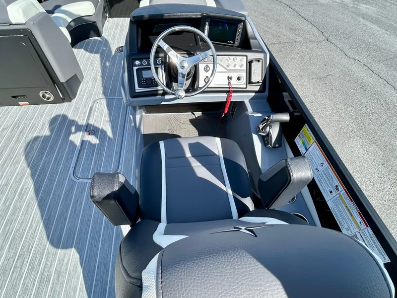 Slide: The Image of 2025 Berkshire 23UL STS 3.0 boat interior with steering wheel and seating. - 14