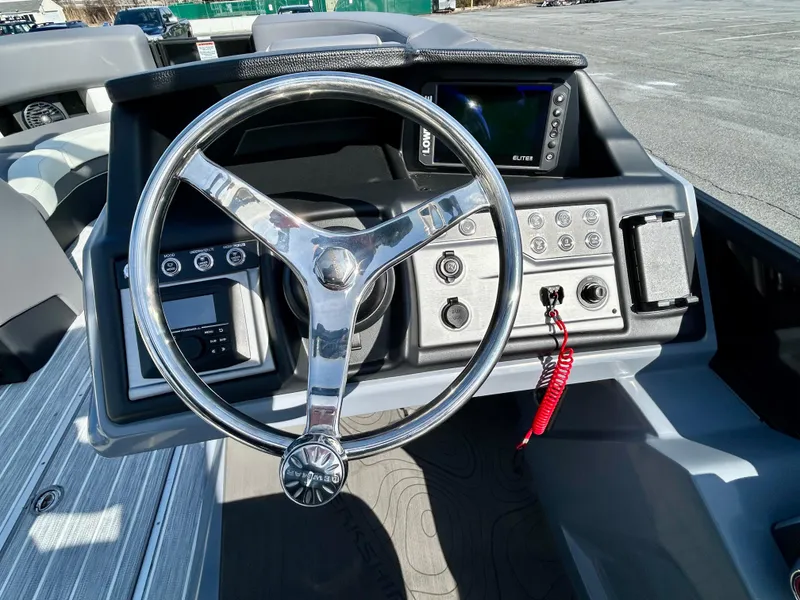 Slide: The Image of Steering console of 2025 Berkshire 23UL STS 3.0 boat with modern controls and display. - 15