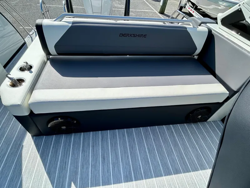 Slide: The Image of 2025 Berkshire 23UL STS 3.0 boat seating with cup holders and striped flooring. - 17