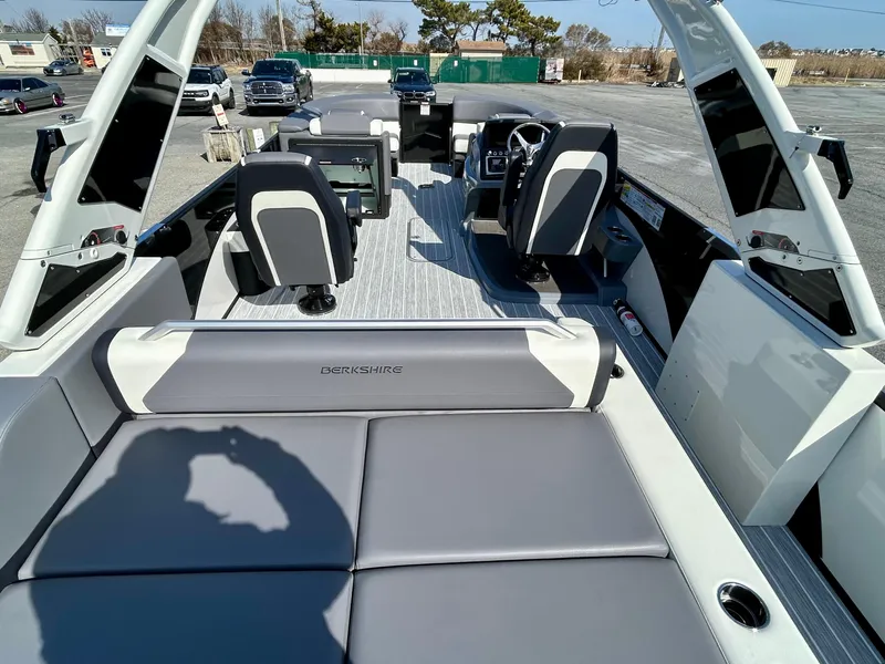 Slide: The Image of 2025 Berkshire 23UL STS 3.0 boat interior with modern seating and steering console. - 18