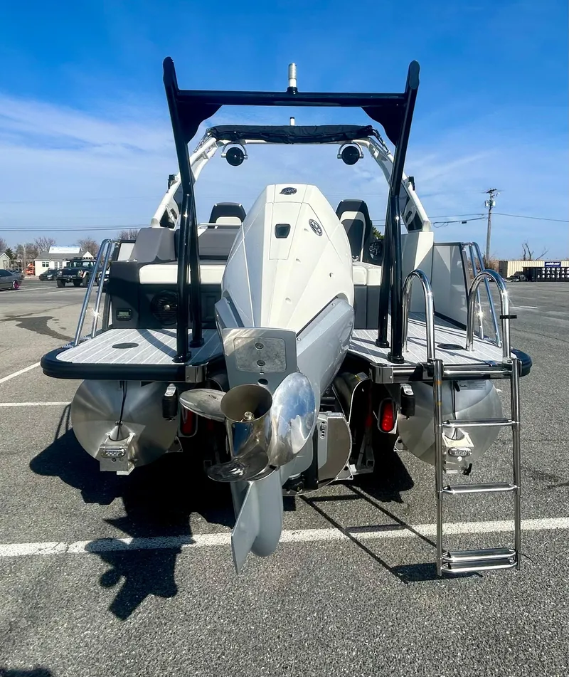 Slide: The Image of 2025 Berkshire 23UL STS 3.0 boat with powerful outboard motor in a parking lot. - 21