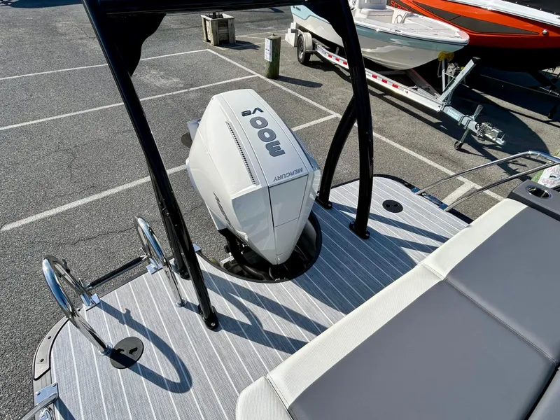 Slide: The Image of 2025 Berkshire 23UL STS 3.0 boat with a powerful outboard motor, docked on a sunny day. - 22