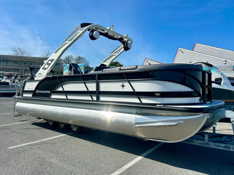 Slide: The Image of 2025 Berkshire 23UL STS 3.0 pontoon boat in a parking lot. - 3