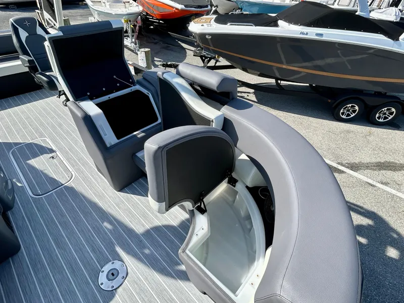 Slide: The Image of 2025 Berkshire 23UL STS 3.0 boat interior with open storage compartments. - 8