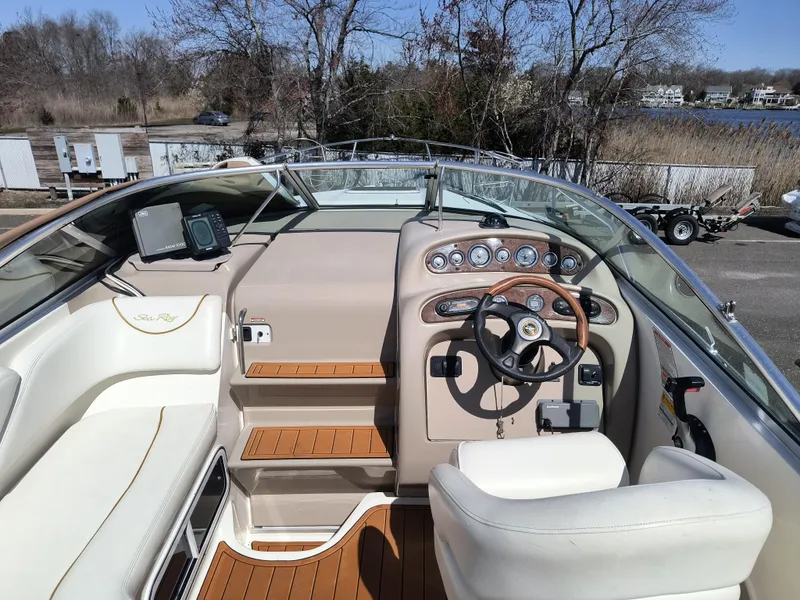 Slide: The Image of 2001 Sea Ray 260 Sundancer boat interior with steering wheel and dashboard controls. - 11