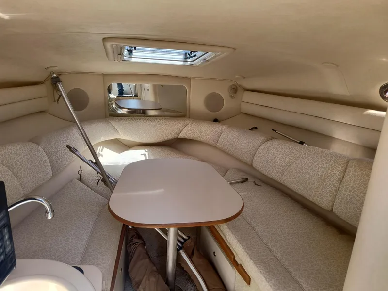 Slide: The Image of Interior cabin of a 2001 Sea Ray 260 Sundancer with seating and table. - 13